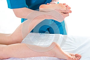 Patient at the physiotherapy doing physical exercises with his therapist