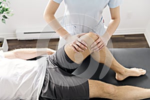 Patient at the physiotherapy doing physical exercises with his therapist photo