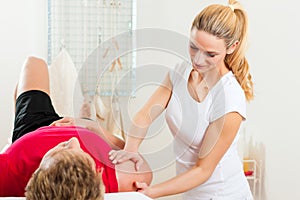 Patient at the physiotherapy doing physical therapy photo