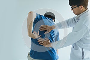 Patient is pointing to the point where the muscle pain is provided to the physical therapist to check photo