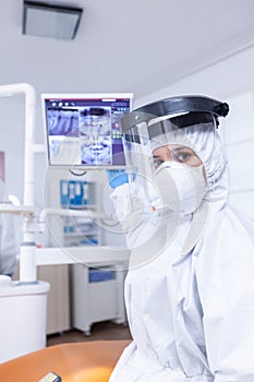 Patient pov in dental office looking at doctor showing digital teeth x-ray on monitor