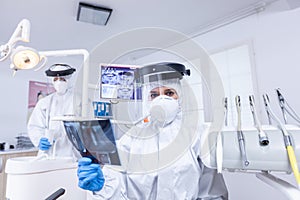 Patient pov of dentist examining patient teeth x-ray