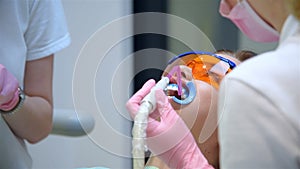 Patient with protective glasses for teeth whitening procedure.