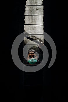 Patient quarantined for contagious lethal disease.Isolation.Prison during epidemic.Person wearing surgical protective mask photo