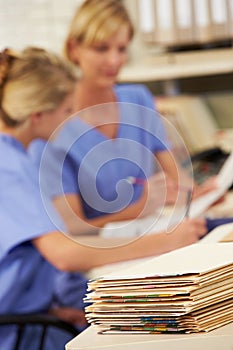 Patient Records On Desk At Nurses Station