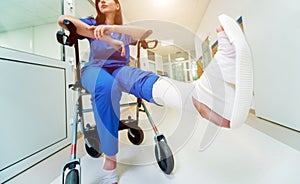Patient on rollator with hand brakes moving in hospital
