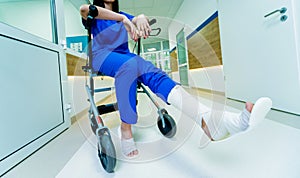 Patient on rollator with hand brakes moving in hospital