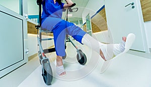 Patient on rollator with hand brakes moving in hospital