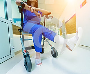 Patient on rollator with hand brakes moving in hospital