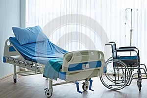 Patient room in hospital.  Bed and medical equipped with wheelchair for comfortable patient.