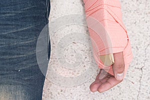Patient`s Arm were unite with cardboard and elastic bandage. Closed-up.