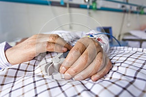 The patient's hand on the bed