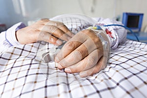The patient's hand on the bed