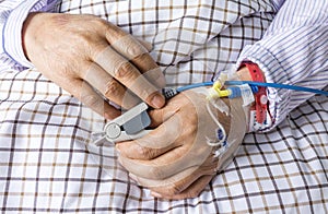 The patient's hand on the bed