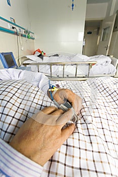 The patient's hand on the bed