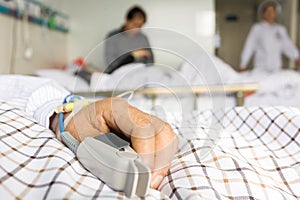 The patient's hand on the bed