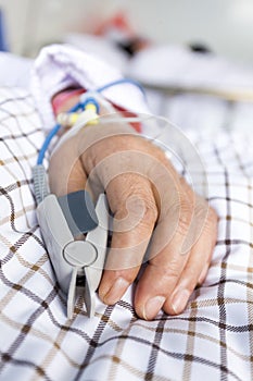 The patient's hand on the bed