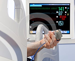 Patient's Hand in Bed with Oximeter