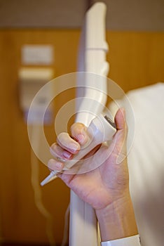 Patient`s hand holding the emergency call button