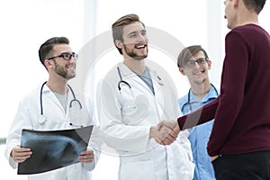 Patient shaking hands with doctor.