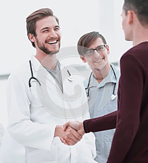 Patient shaking hands with doctor.