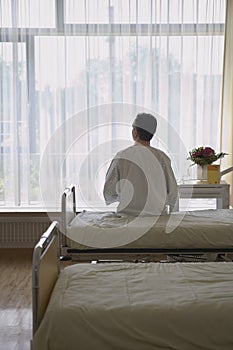 Patient Sitting In Hospital Bed