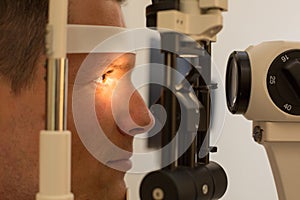 Patient at slit lamp of optician or optometrist