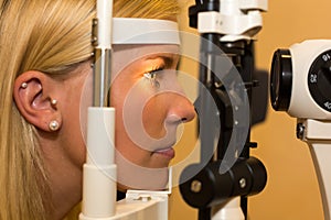 Patient at slit lamp of optician or optometrist photo