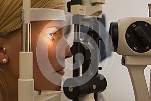 Patient at slit lamp of optician or optometrist photo