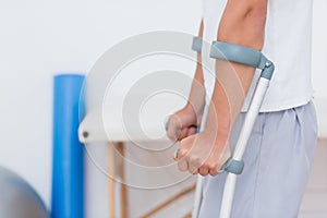 Patient standing with crutch