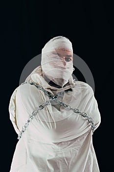 Patient in straitjacket and chains