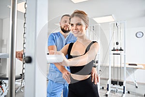 Patient strengthens her back muscles under the supervision of kinesiologist