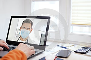 Patient talking online via video call with his doctor