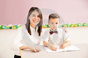 Patient teacher helping a student in class