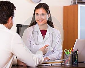 Patient and therapeutist at desk in clinic