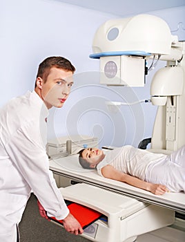 Patient with trauma and doctor in x-ray room.