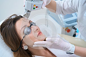 Patient undergoes a procedure for laser removal of neoplasms in the forehead