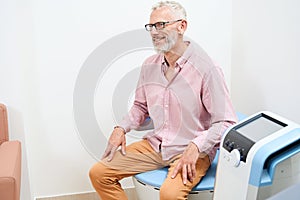 Patient undergoing physiotherapy procedure to stimulate pelvic floor muscles