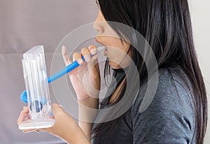 Patient using incentivespirometer or three balls for stimulate lung,Selective focus