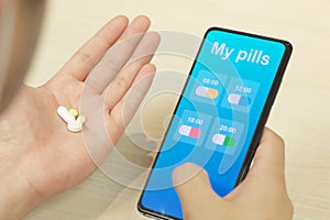 A patient using mobile application for reminding her medical pills