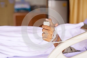 Patient using nurse alarm button for emergency belled on sickbed at hospital