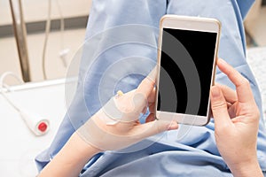Patient using smart phone in hospital
