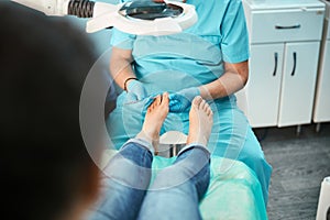 Patient visiting chiropodist podiatrist in beauty center