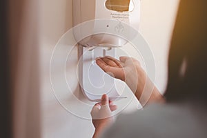 Patient woman using automatic alcohol dispenser sanitation for cleaning hands in hospital,Protection spread of coronavirus