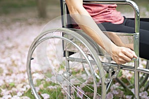 Patient woman using a wheelchair in a park hospital