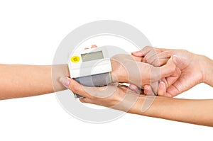 Patients arm with glucose measure meter around wrist and doctors hands holding supporting