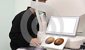 Patients are examining their eyesight with a fundus non-mydriatic camera in a screening room for patients at risk of diabetes