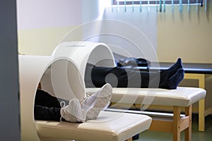 Magnet Therapy Procedure.Patients lying down with legs inside circular magnetic therapy devices during a physiotherapy