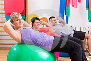 Patients at physiotherapy on training balls