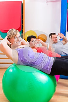 Patients at physiotherapy on training balls